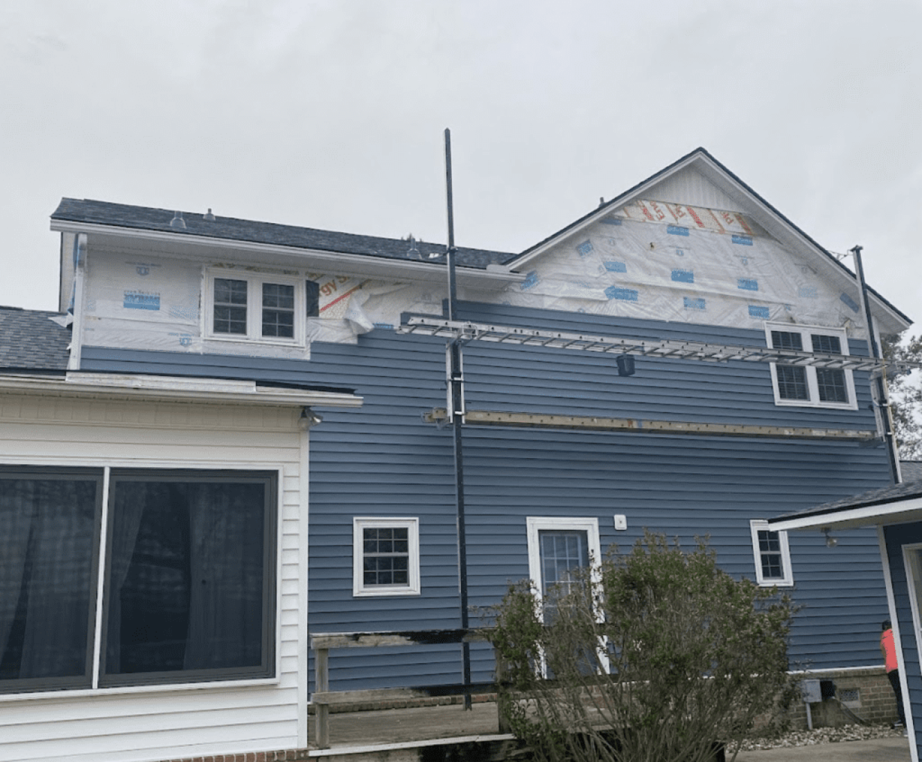 Technicians from Coastal Siding & Windows installing new energy-efficient windows on a home in Charleston, SC